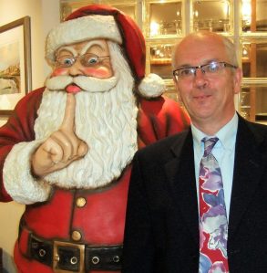 Picture of author posing by Santa Claus